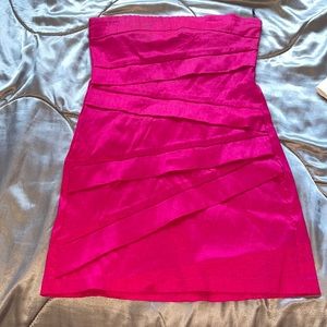 A magenta pink strapless skin tight mini dress